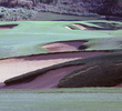 The 13th hole at The Dunes at Maui Lani G.C. features fairway and greenside bunkers, making it one of the course's trickier par-5 holes. 