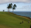 The fairway of Kauai Lagoons Golf Club's par-4 16th hole narrows and heads downhill towards the green.