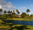 Kauai Lagoons Golf Club's 18th hole is a long par 4 that requires carry over water and into the trade winds.