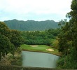 Puakea Golf Club's par-3 sixth hole plays from an elevated green down to a green guarded by water.