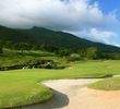 The par-5 11th hole at King Kamehameha Golf Club features water and waterfalls in front of the green. 