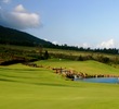 A waterfall runs into a pond at King Kamehameha Golf Club's 14th hole. 