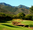 The par-3 sixth hole at Kahili Golf Course plays uphill over a rock bed. 