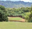 The sixth hole at Puakea Golf Course drops off a ridge to a green below. 