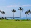 The 16th hole at Mauna Kea Golf Course doglegs right to reveal the ocean. 