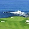 A view of a green with water in background at Mauna Kea Golf Course