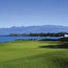 A view of a green with water in background at Mauna Lani Resort.